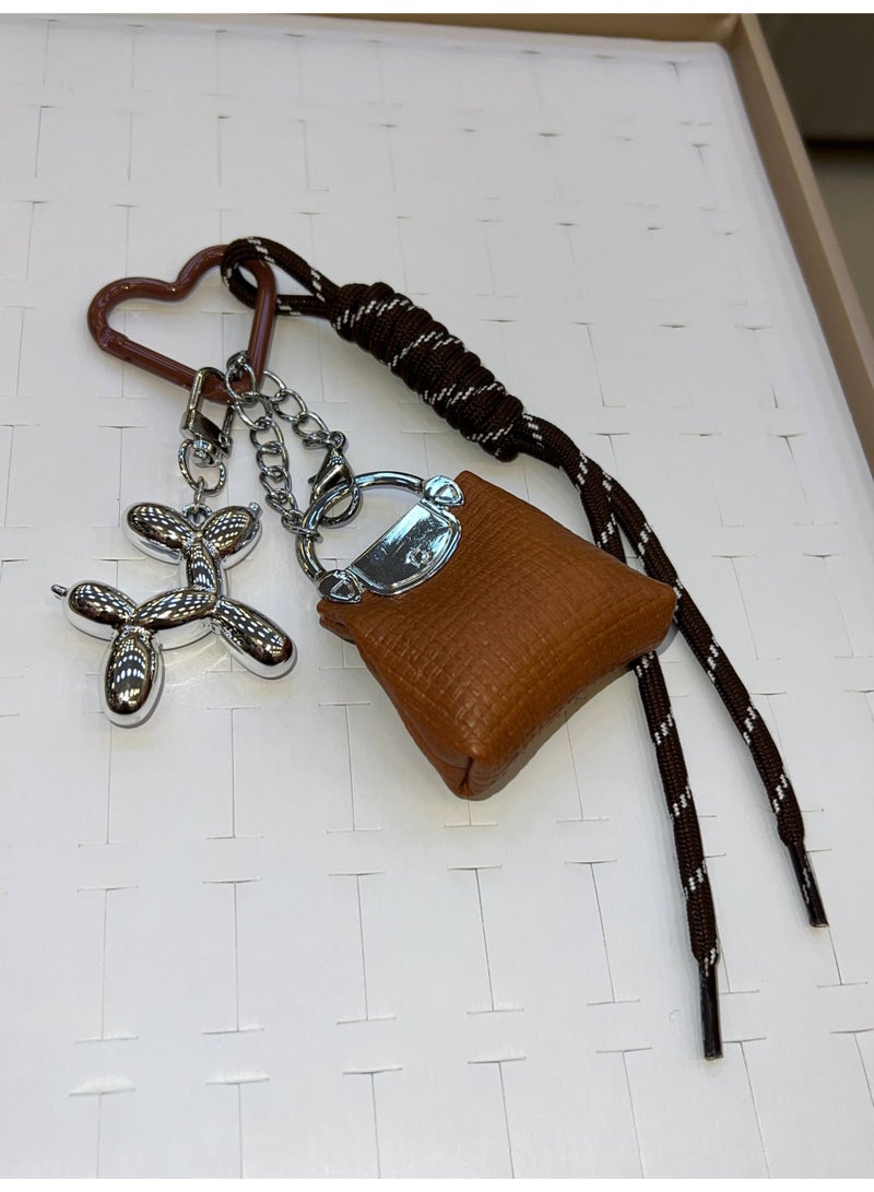 A stylish heart-shaped bag and keychains in assorted colors - Image 3